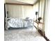 Cozy bedroom with a white metal bed frame, plush carpet, and sunny windows at 4007 Cypress Lndg S, Winter Haven, FL 33884