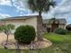 Charming home exterior featuring a well-manicured front yard with lush landscaping and curb appeal at 4007 Cypress Lndg S, Winter Haven, FL 33884