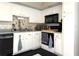 Well-maintained kitchen featuring white cabinets, neutral countertops and modern appliances at 4007 Cypress Lndg S, Winter Haven, FL 33884