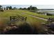 Scenic lake view from the community area, featuring benches and a walking path at 4007 Cypress Lndg S, Winter Haven, FL 33884