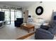 Bright living room with comfortable seating, a sliding glass door, and modern décor at 4007 Cypress Lndg S, Winter Haven, FL 33884