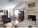 Cozy living room with a brick fireplace, comfortable seating, and an open floor plan at 4007 Cypress Lndg S, Winter Haven, FL 33884