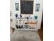 White shelving unit perfect for displaying home decor in a living room with a rug at 4007 Cypress Lndg S, Winter Haven, FL 33884