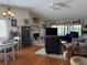 Spacious living room features a fireplace, dining area, sliding glass doors, and comfortable seating at 4007 Cypress Lndg S, Winter Haven, FL 33884