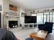 Comfortable living room featuring a brick fireplace, a large TV, and sliding glass doors to the outside at 4007 Cypress Lndg S, Winter Haven, FL 33884