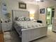 Cozy main bedroom with a full bed set, complimented with white nightstands and artwork at 4007 Cypress Lndg S, Winter Haven, FL 33884