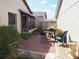 Cozy brick patio with outdoor seating and lush greenery at 4007 Cypress Lndg S, Winter Haven, FL 33884