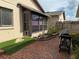 Charming brick patio with artificial grass and a dog laying down at 4007 Cypress Lndg S, Winter Haven, FL 33884