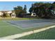 Community tennis court offers an outdoor recreational amenity for residents at 4007 Cypress Lndg S, Winter Haven, FL 33884
