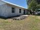 View of the backyard from the house showing a patio and some landscaping potential at 403 Se 3Rd St, Fort Meade, FL 33841