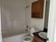 Cozy bathroom with a toilet, a shower/tub combo, and a vanity with a black countertop at 403 Se 3Rd St, Fort Meade, FL 33841