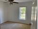 Bedroom featuring a ceiling fan, plush carpeting, and a large window at 403 Se 3Rd St, Fort Meade, FL 33841