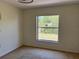 Bedroom with window, neutral carpet, baseboard, and electrical outlets at 403 Se 3Rd St, Fort Meade, FL 33841