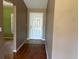 Inviting foyer with wood flooring and views of a room with green walls at 403 Se 3Rd St, Fort Meade, FL 33841