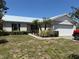 Charming one-story home with a metal roof, small front porch, and attached two-car garage at 403 Se 3Rd St, Fort Meade, FL 33841