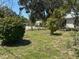 Well-maintained front yard with lush landscaping and mature trees providing curb appeal at 403 Se 3Rd St, Fort Meade, FL 33841