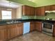 A well-lit kitchen with stainless steel range, tile floor, and wooden cabinets at 403 Se 3Rd St, Fort Meade, FL 33841