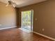 Living room with wood floor and a sliding glass door leading to the backyard at 403 Se 3Rd St, Fort Meade, FL 33841
