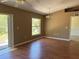 Spacious living room with wood floors, sliding glass door, and a view of the backyard at 403 Se 3Rd St, Fort Meade, FL 33841