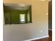 Pass through bar between dining and kitchen with view of the kitchen window at 403 Se 3Rd St, Fort Meade, FL 33841