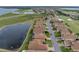 Aerial view of a residential street adjacent to a tranquil lake at 4081 Dunmore Dr, Lake Wales, FL 33859