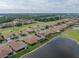 Aerial view of home overlooking a serene pond and golf course at 4081 Dunmore Dr, Lake Wales, FL 33859