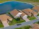 Aerial shot of a home with lake view, well-kept lawn, and solar panels on the roof at 4081 Dunmore Dr, Lake Wales, FL 33859