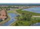 An aerial view of the neighborhood that features a lake and golf course at 4081 Dunmore Dr, Lake Wales, FL 33859
