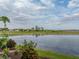 Beautiful backyard view overlooking a serene lake and lush green space at 4081 Dunmore Dr, Lake Wales, FL 33859