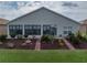 Home's exterior showcasing a well-maintained backyard with manicured landscaping and a glimpse of nature at 4081 Dunmore Dr, Lake Wales, FL 33859