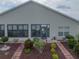 Exterior of home highlighting the manicured backyard with brick-lined garden beds and a charming walkway to the house at 4081 Dunmore Dr, Lake Wales, FL 33859