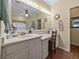 Bathroom vanity area featuring good lighting, a large mirror, and cabinets at 4081 Dunmore Dr, Lake Wales, FL 33859