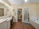 Bright bathroom featuring a vanity, shower, and separate tub at 4081 Dunmore Dr, Lake Wales, FL 33859