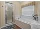 Bathroom showcasing a separate shower and soaking tub beneath a window at 4081 Dunmore Dr, Lake Wales, FL 33859