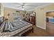 Bedroom featuring wood floors, dresser with TV, and view into the kitchen at 4081 Dunmore Dr, Lake Wales, FL 33859