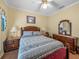Cozy bedroom featuring a comfortable bed, wooden furniture, and soft, natural lighting at 4081 Dunmore Dr, Lake Wales, FL 33859