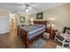 Comfortable bedroom with wood flooring, ceiling fan, and a classic quilt-covered bed at 4081 Dunmore Dr, Lake Wales, FL 33859