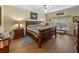 Bedroom featuring a dark wood bed frame, side tables with lamps, an area rug, and a ceiling fan at 4081 Dunmore Dr, Lake Wales, FL 33859