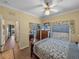Comfortable bedroom with ceiling fan, mirrored closet, and wood-look flooring at 4081 Dunmore Dr, Lake Wales, FL 33859