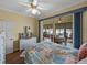 Inviting bedroom adjacent to a sunroom with a white dresser and a ceiling fan at 4081 Dunmore Dr, Lake Wales, FL 33859