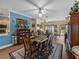 Formal dining room with a wood table, area rug, wood floors, large windows, and views to other rooms at 4081 Dunmore Dr, Lake Wales, FL 33859
