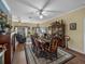 Formal dining room with a wood table, area rug, wood floors, large windows, and views to the living room at 4081 Dunmore Dr, Lake Wales, FL 33859