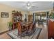 Formal dining room with a wood table, area rug, wood floors, large windows, and a ceiling fan at 4081 Dunmore Dr, Lake Wales, FL 33859