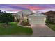 Charming single-story home featuring a brick driveway, meticulous landscaping, and an American flag at 4081 Dunmore Dr, Lake Wales, FL 33859