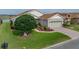 Inviting one-story home with an attached garage, lush lawn, and vibrant landscaping at 4081 Dunmore Dr, Lake Wales, FL 33859