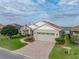 Beautiful single-story home with a two-car garage, brick driveway, and well-manicured landscaping at 4081 Dunmore Dr, Lake Wales, FL 33859