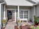 Cozy front porch with brick flooring, decorative plants, and a charming bench, creating a welcoming entrance at 4081 Dunmore Dr, Lake Wales, FL 33859