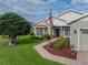 Charming home boasts a well-manicured lawn, mature tree, and beautiful landscaping surrounding the entrance at 4081 Dunmore Dr, Lake Wales, FL 33859