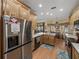 Bright kitchen featuring wood cabinets, marble countertops, stainless steel appliances, and views to the outdoor area at 4081 Dunmore Dr, Lake Wales, FL 33859