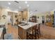 Spacious kitchen with wood cabinets, marble countertops, seating at island, with views to dining area at 4081 Dunmore Dr, Lake Wales, FL 33859